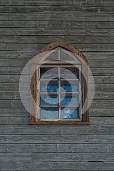 One window on a wooden church wall