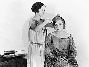 One woman doing another woman's hair