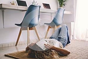 One woman at home lay down on the carpet covering her face with a book. Concept of education and student middle age. Female people