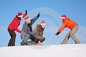 One woman pull two men on sled
