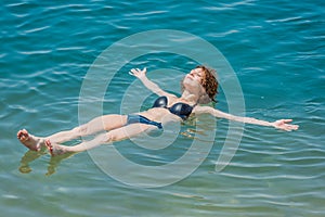 One woman swimming bathing in dead sea jordan