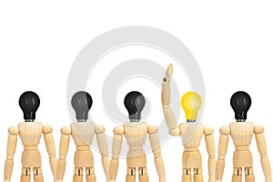 One wooden figure mannequin with yellow light bulb head standing out row of other figures with black light bulb on head.