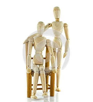 Giving healthcare to wooden puppet sitting on chair