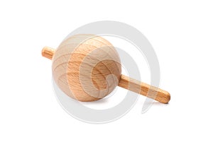 One wooden spinning top isolated on white. Toy whirligig