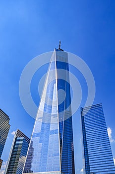 The One World Trade center or Freedom Tower located in New York City. Architectural modern buildings at lower Manhattan skyline.