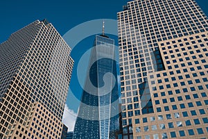 One World Trade Center tower in lower Manhattan against clear blue sky in New York City