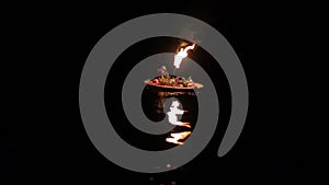 One wreath with torch floats down the river.