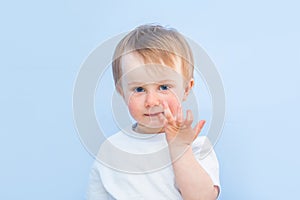 One year nine month old boy portrait on blue background