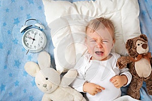 One year old baby with alarm clock