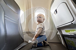 One year old baby boy by airplain`s window