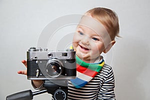 One year old baby boy with camera