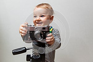 One year old baby boy with camera