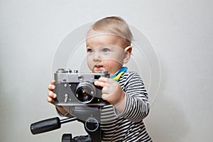 One year old baby boy with camera