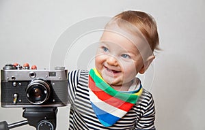 One year old baby boy with camera