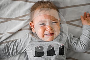 One year old baby crying in bed