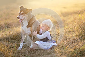 One Year Old Baby Lovingly Holding Her Pet German Shepherd Dog