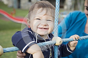 One year old baby smiling at playground