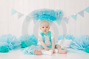 A one-year-old boy celebrates his first birthday. Blue-white color scheme