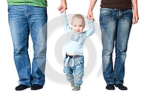 One year old boy holding hands of parents