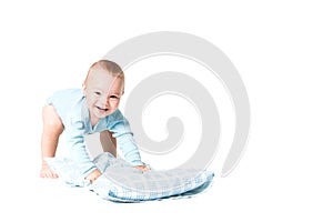 One year old boy playing with the pillow