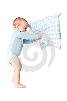 One year old boy playing with the pillow