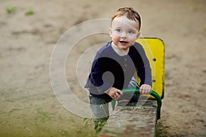 One-year-old boy is playing on a playground