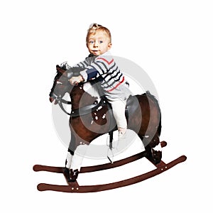 One year old boy riding on rocking horse