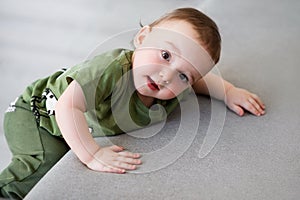 One-year-old boy tries to climb