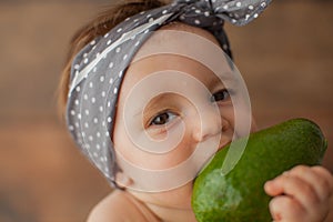 One year old girl eating fruits. Portrait.