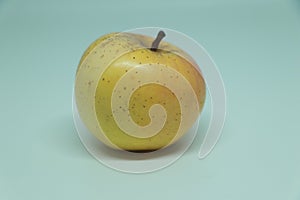 One yellow Apple close-up on a white. Isolated, golden delicious apples isolated