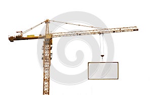 One yellow hoisting crane and advertisement hoardin photo