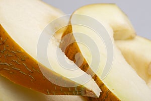 One yellow honeydew melon slice without seeds