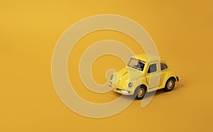 One yellow toy car on bright yellow background. Taxi abstract concept