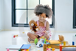 One young African girls play toys and look fun and enjoy
