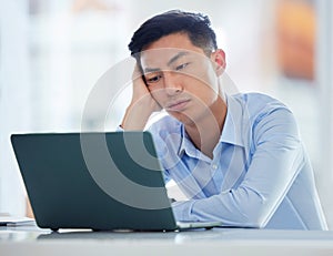 One young asian business man looking bored, tired and demotivated while waiting on slow laptop connection error. Lazy