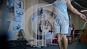 One young athletic man doing double unders jump rope exercise at the gym