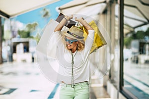 One young and beautiful woman buying gifts and clothes and walking in the mall shopping outdoor