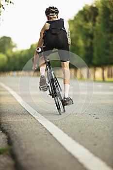 Young male cyclist riding a road bike in summer day. Action, motion concept