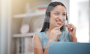 One young hispanic happy and cheerful female call center agent wearing a headset and working in customer service at work