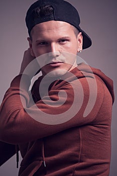 One young man, early 20s, boyish looks, posing in studio, casua