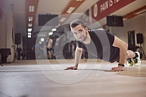 One young man push up exercise on gym floor.