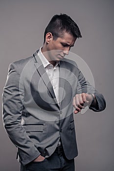 One young man, upper body, formal clothes, looking to watch