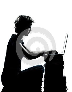 One young teenager boy or girl silhouette computer computing lap