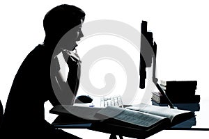 One young teenager boy girl silhouette studying with computer c