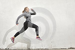 One young woman smiling happy, jumping in mid-air,