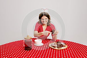 One young woman, strange waitress in 70s, 80s retro fashion style uniform sitting at table with coffee over grey