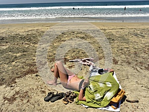 One young woman sunbathing on sand beach Baja, Mexico