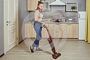 One young woman uses a wireless vacuum cleaner
