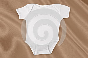 Onesie Mockup on Elegant Golden Fabric