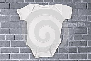 Onesie Mockup on Industrial Gray Brick Background